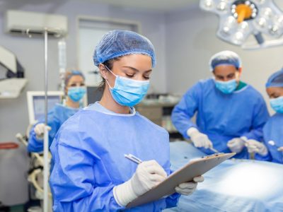 Surgeon writing on clipboard in operation room